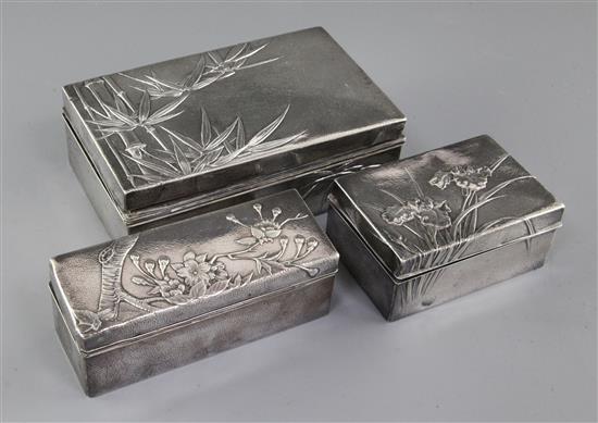 Three early 20th century Japanese textured silver toilet boxes, two signed Miyamoto Shoko, largest 6in.